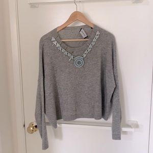 Wool and cachemire grey sweater with necklace sawn on it. Size 1.